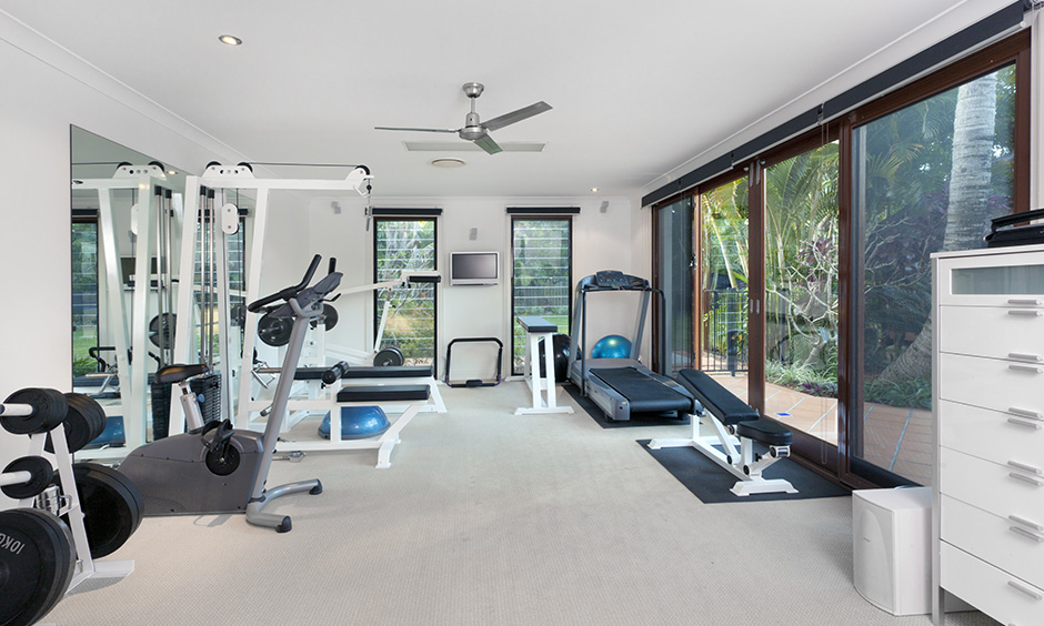 Cool home gym design ideas with a lovely bay window and variety of equipment