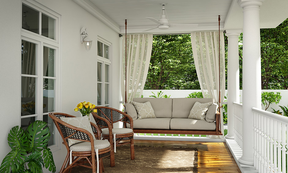 White home front porch design adding a comfortable swing for a refreshing summery look and in winter add throw blankets.