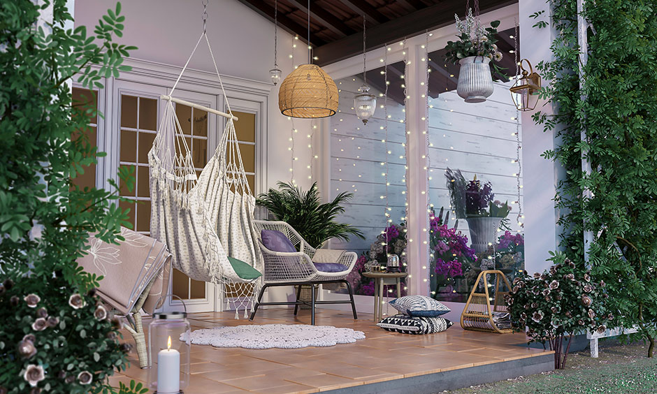 House with porch add white hammock, throw pillows, a wicker chair and fairy lights make it a great spot to entertain