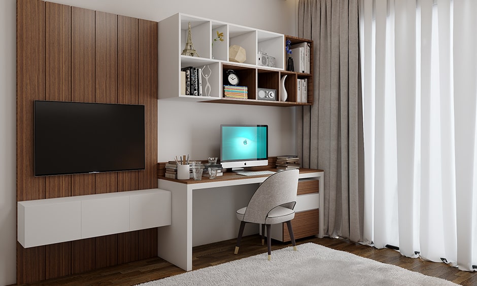 Modern study table designs attached to a tv unit built with shelves for storage