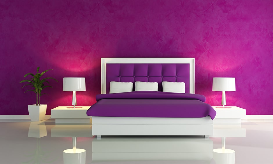 Purple bedroom with a textured purple wall and tinge of pink