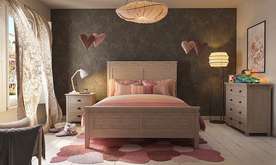 Pink and beige coloured romantic lighting bedroom with pastel pink paper chandelier and a golden lamp adorned.