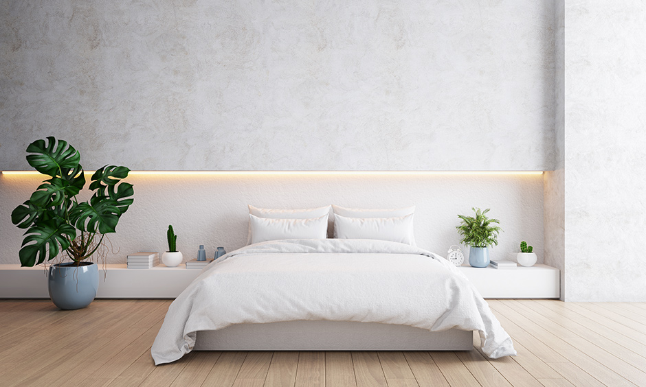 Zen-inspired minimalist white bedroom design is peaceful with strip lighting and creates a romantic lighting vibe.