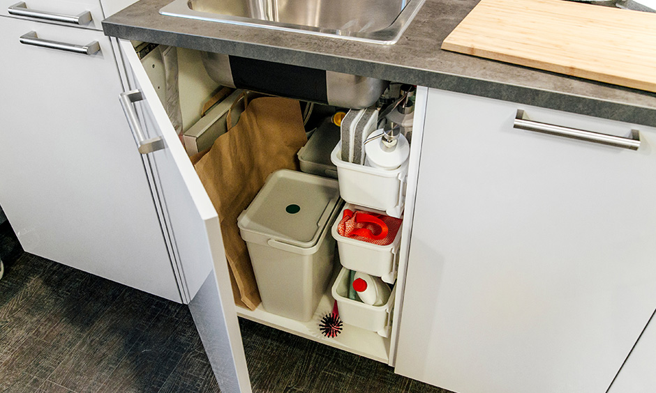 Under sink counter storage in the kitchen keep cleaning supplies, scrubbers, in an easy-to-pull out caddy for clutter-free.