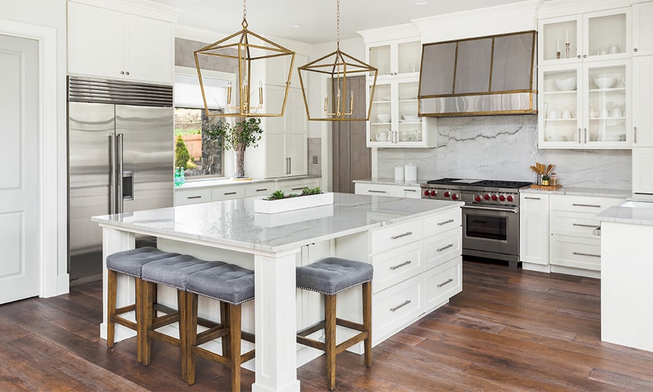 White kitchen cabinets for island kitchen design with a marble countertop