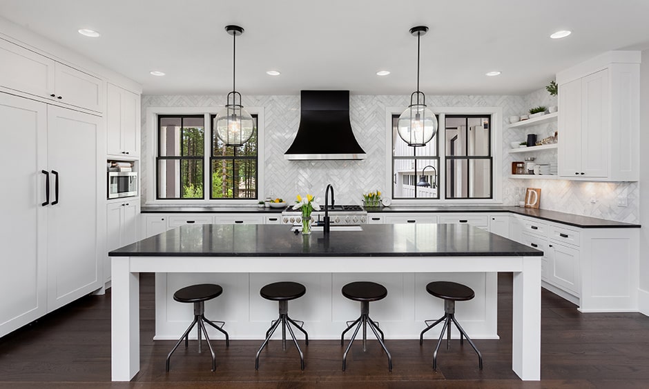 White kitchen cabinets images with a black countertop, black chairs and black chimney