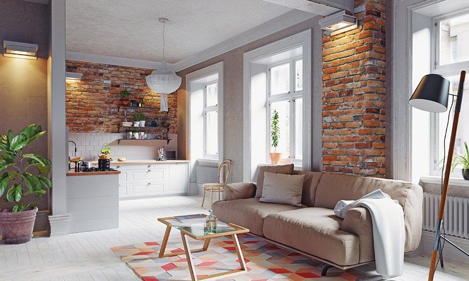 Wooden coffee table with a glass top in brick-walled living room