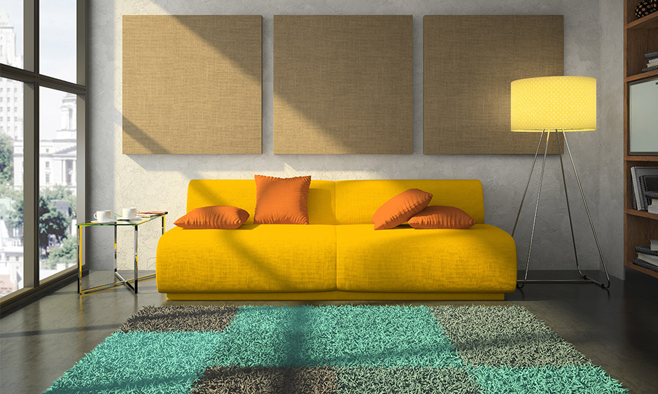 Beige wall and splashes of yellow such as a sofa with orange cushions feel summery & bright in beige and yellow living room