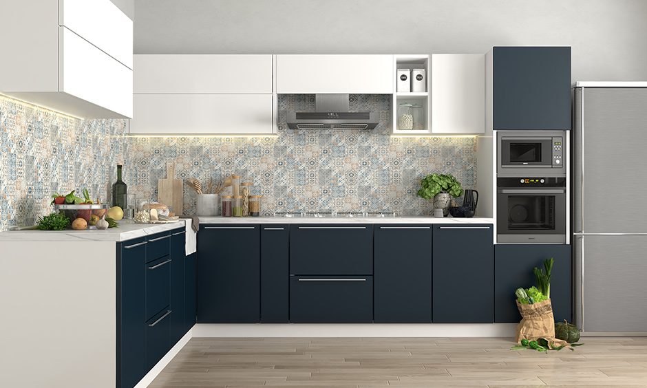 Blue and cream kitchen ideas, solid blue kitchen units and with a multi-coloured tile design on the walls look spacious.