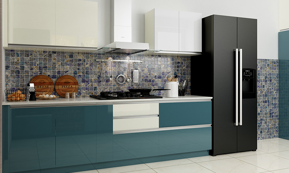 Patterned blue square tiles on the wall match well with the blue kitchen furniture and are a good option.