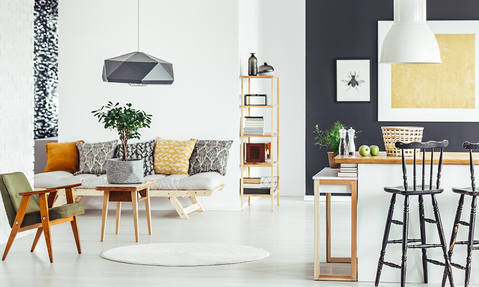 Chic rustic theme living room with cane furniture, indoor plants, and wall accents over encompassing white paint