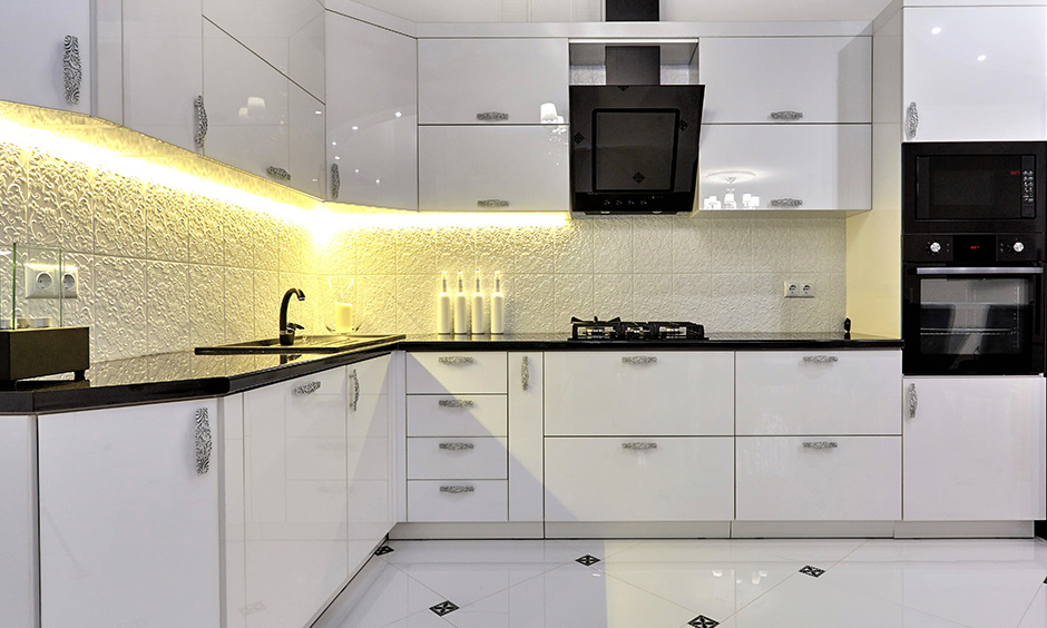 White-themed, lacquered corner unit kitchen cabinet with LED lighting under cabinet exudes freshness and brightness.