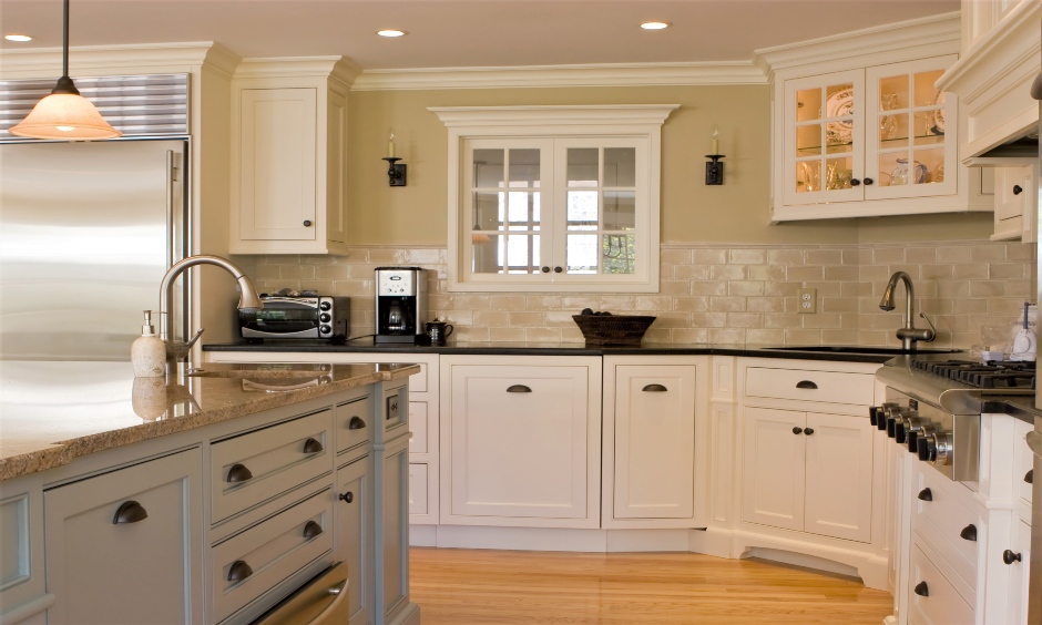 Corner kitchen sink cabinet with glass-doored looks traditional and classy.