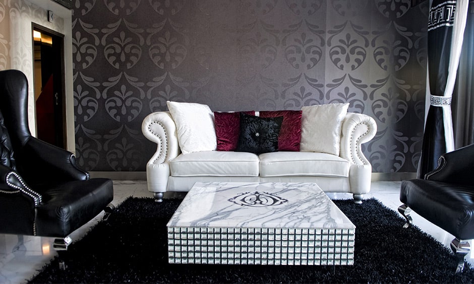 Dark grey themed living room design with dark-grey floral patterned wall