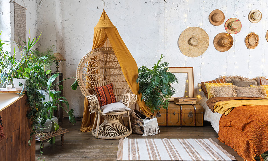 cane armchair and hats hanged on wall is bohemian decor ideas for your home