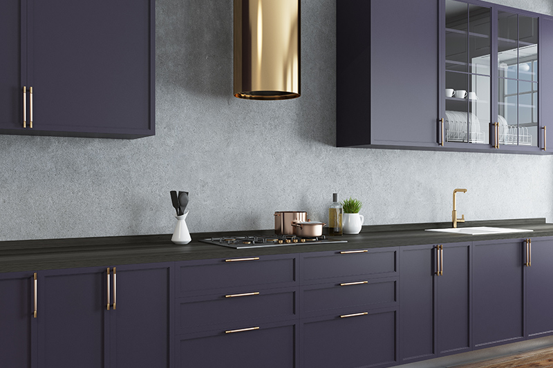 Modern grey kitchen cabinets in matte finish with gleaming copper detailing 