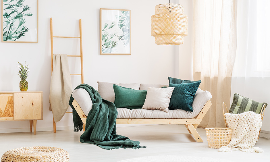 Grey rustic cottage living room furniture with placement of bamboo and cane lamps, a chic sofa, and umpteen indoor plants