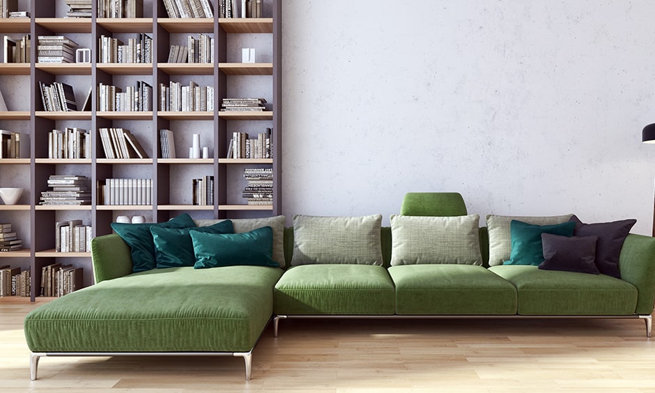 Home library interior design with l-shaped sectional sofa and plush pillows