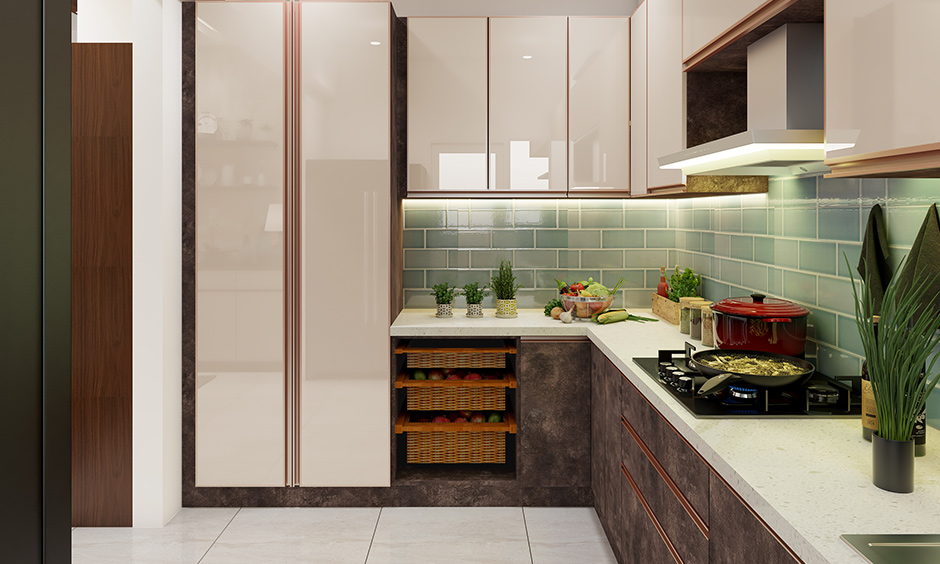 This L shaped modular kitchen in Bangalore with a pop of colour the dado wall has highlighted with marine green tiles. 