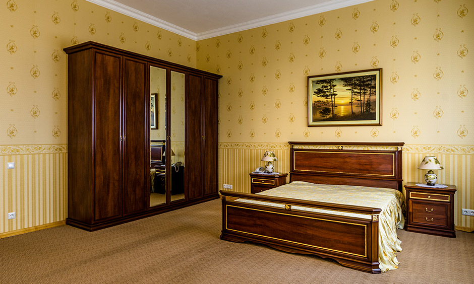 A mix of gold wall texture and subtle golden stripes looks gorgeous for the bedroom