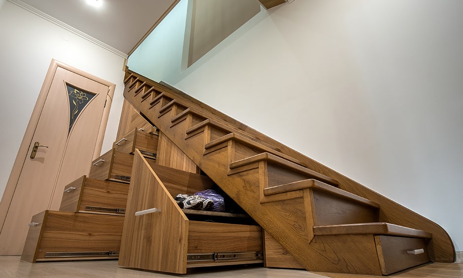 Modern wooden staircase with storage drawers makes great use of free space under stairs