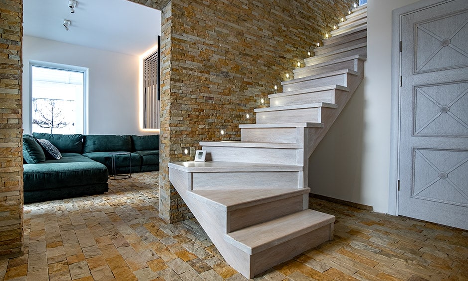 Rustic white wooden staircase design with unusual stone walls