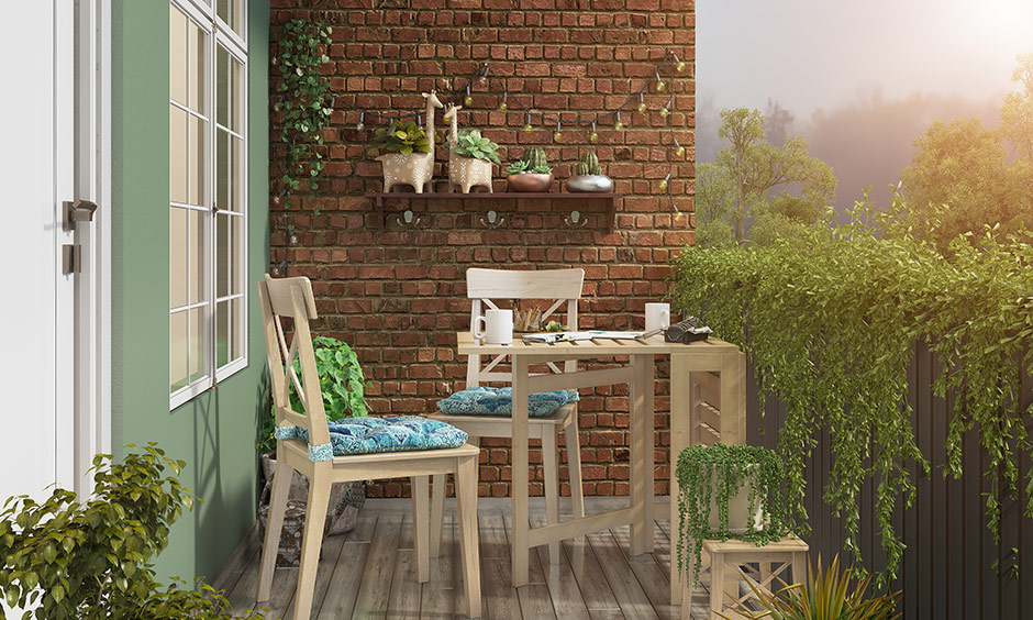 A folding table with comfortable chairs is an excellent idea for small open balcony ideas.