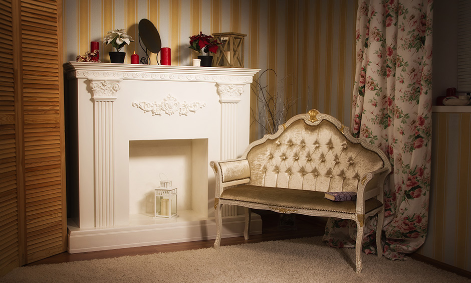 Striped golden wallpaper works well in a cosy reading nook with a modern fireplace