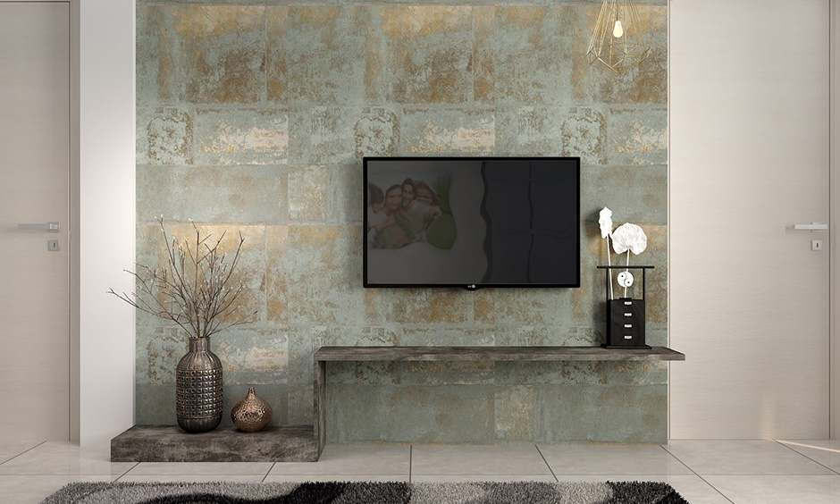 The subtle blue and gold wallpaper add glamour to the space and is a perfect backdrop for the TV unit in the living room