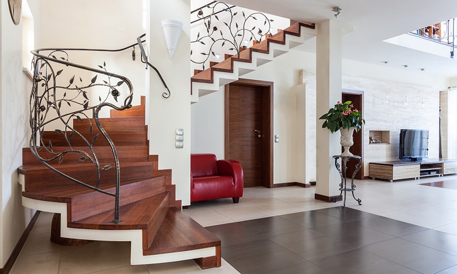 Wooden staircase with an elegant railing adds to the luxury look for indian homes