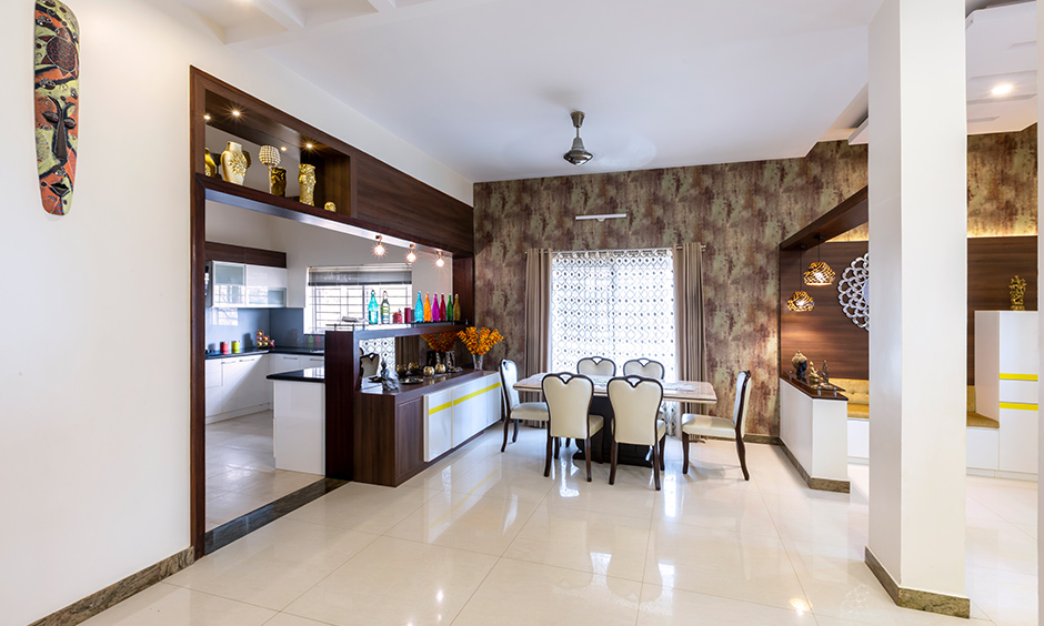 This dining area with a crockery unit that can be accessed looks gorgeous interiors for Rainbow Residency Sarjapur by DC.