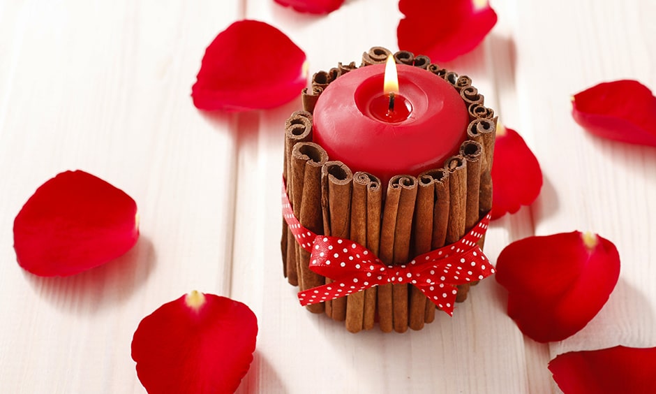 DIY aromatic candles with cinnamon sticks around them