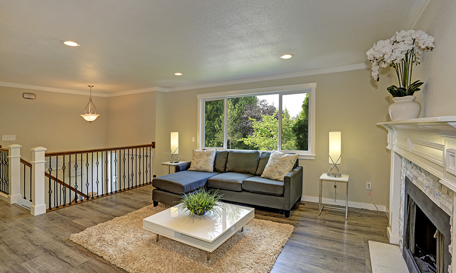 A beige living room wall paint colour with a white ceiling is a simple and elegant look.