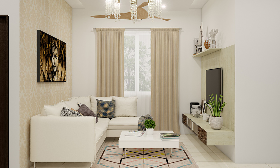 Living room decor with a long chandelier completes and looks modern.