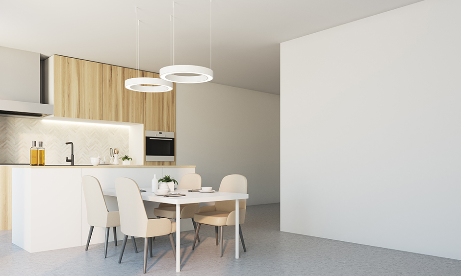 Modern minimalistic led kitchen lighting with dining table above it drop-down ring-shaped light add to the aesthetic