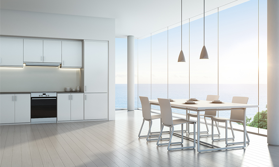 White luxury modern kitchen designs with large bay windows will leave you with a beautiful sea view & blue sky.