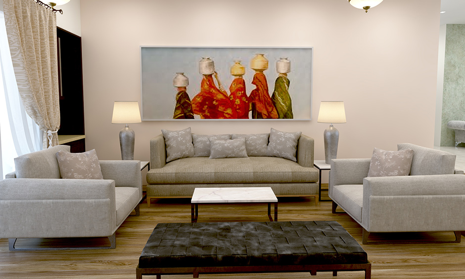 A white living room wall decor with colourful paintings brings soothing effects to the area.