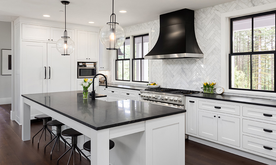 Black marble countertops with white cabinets design in the kitchen island