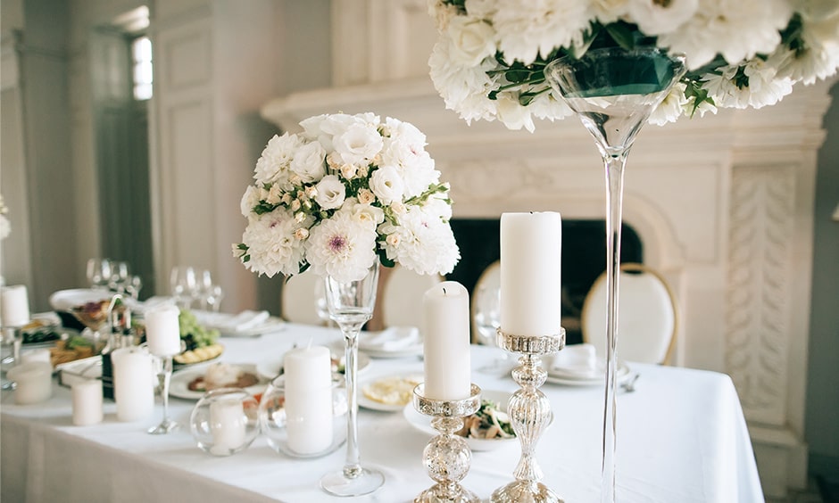 Anniversary party decoration ideas for your home by adding candles, flowers and glass props