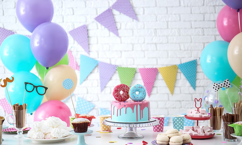 DIY birthday party decoration ideas with paper pinwheels, flowers, balloons and glitter