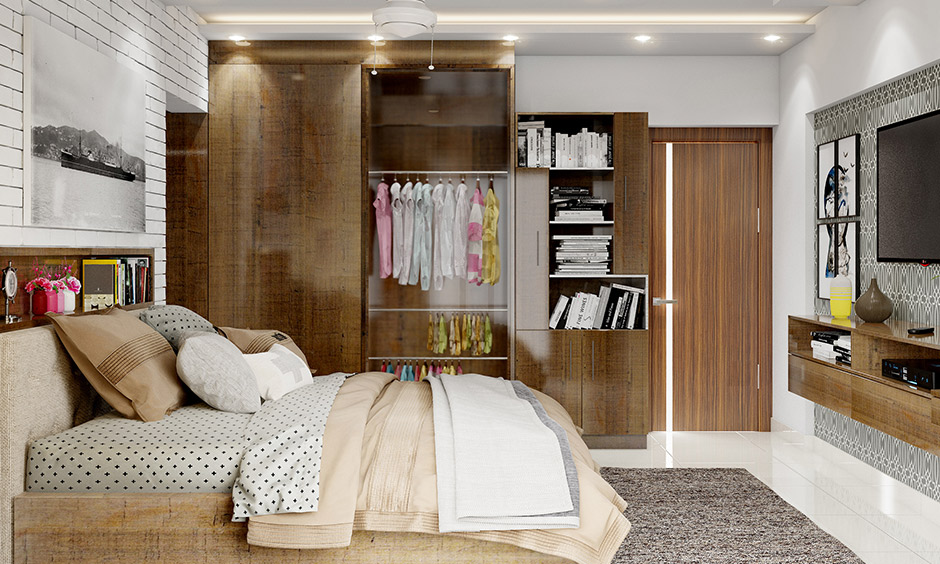 Wooden finish girls wardrobe design with a glass doors showcase of exquisite clothes looks aesthetics.
