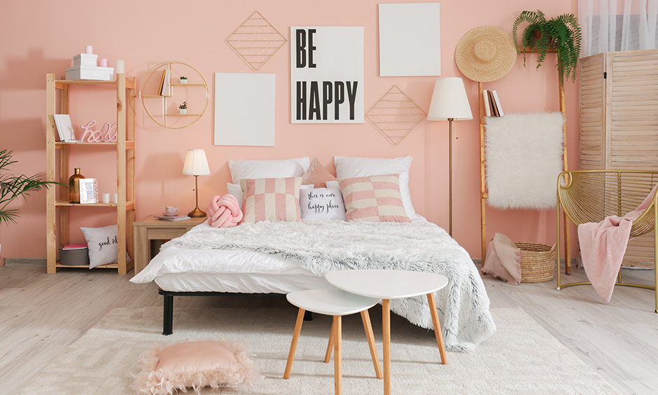 This master bedroom painted in light pink has a quirky and fun touch is light reflecting paint for dark rooms.