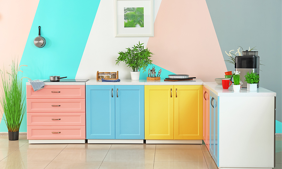 Small kitchen wall decorated in multi-colour with colourful cabinets makes it a small yet feisty space to cook