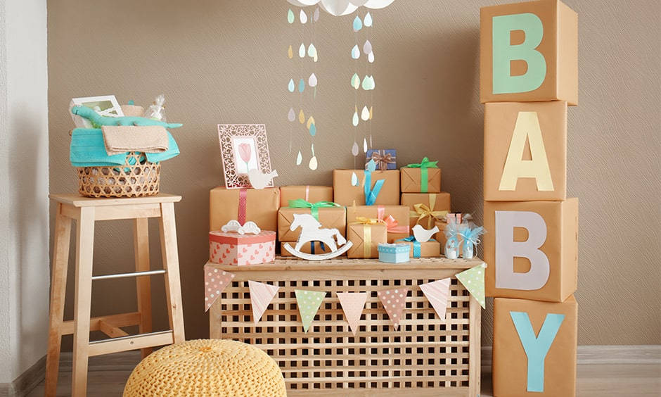 DIY welcome baby party decor ideas with pastel paper hangings