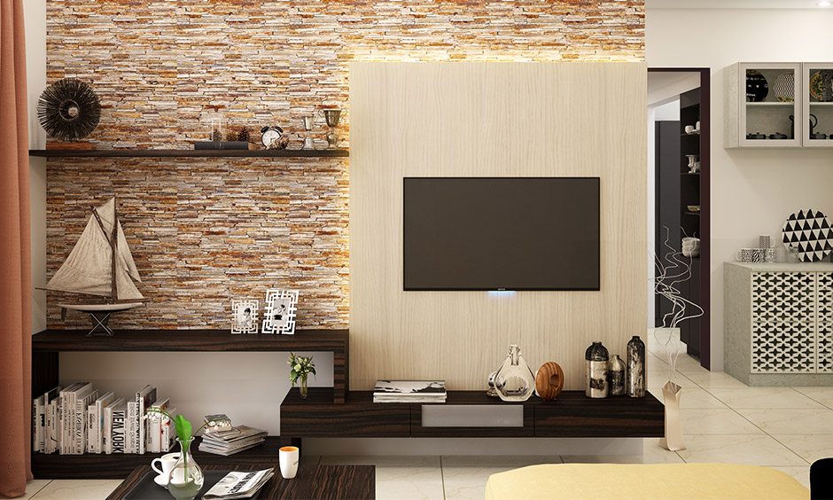 An exposed brick wall is a perfect backdrop for the TV unit & floating shelves is an accent wall ideas for small living room