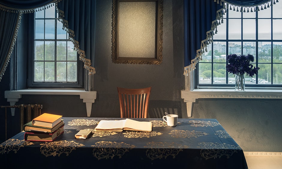 Classic study table decor idea with a rich tablecloth and golden coloured thread