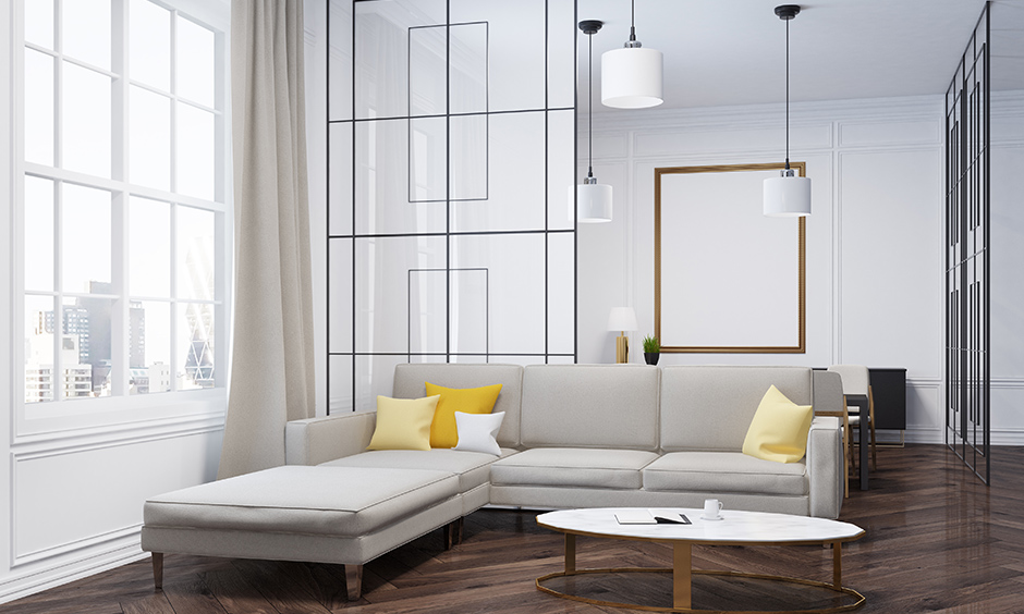 Modern living room in white with patterned glass floor to ceiling hall partition is sophisticated interior design.