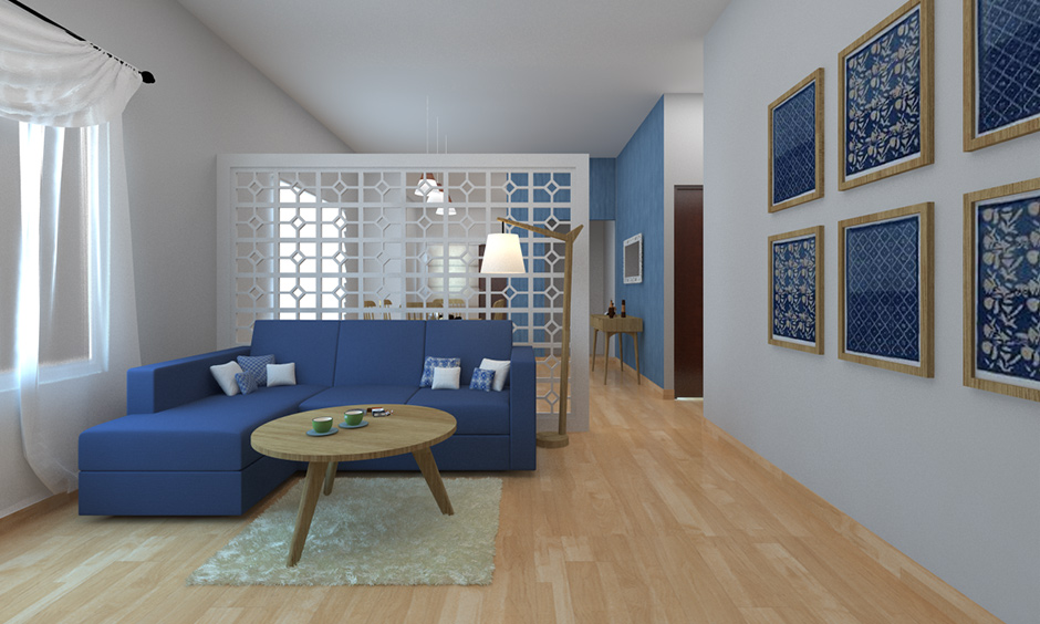 Partition designs in hall with wooden flooring and blue sectioned sofa, an all-white hall stands tall and elegant.