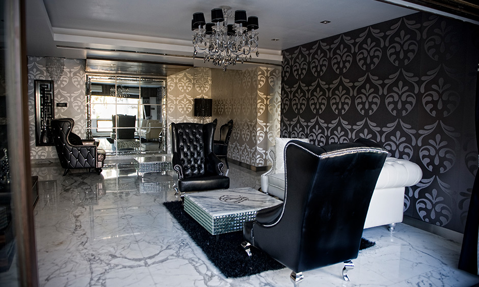 Living room pop plus minus which seamlessly incorporates a crystal chandelier amidst a dark colour scheme