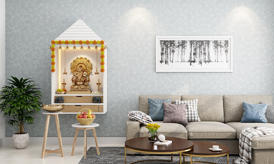 Mandir design in wall with bells, hooks to hang diya's and wood drawers to store pooja items